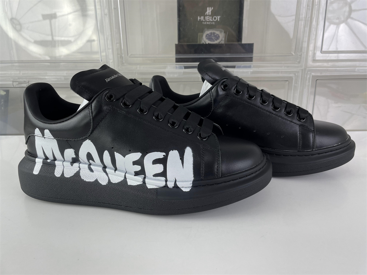 McQueen Black Leather with white words on side
